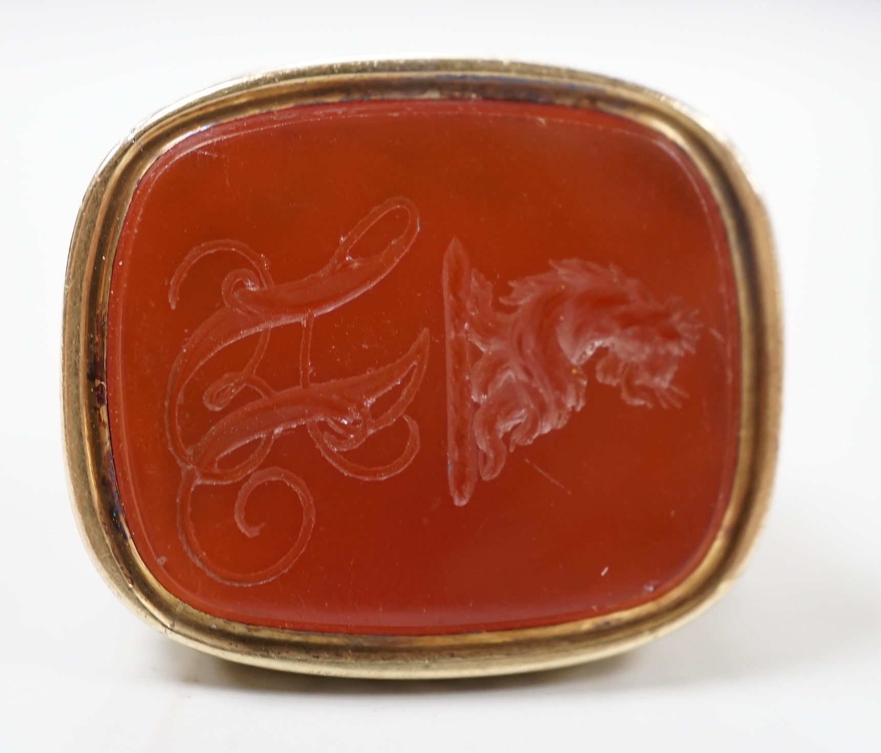 A 19th century yellow metal overlaid and carnelian set fob seal, the matrix carved with crest and monogram, 37mm.